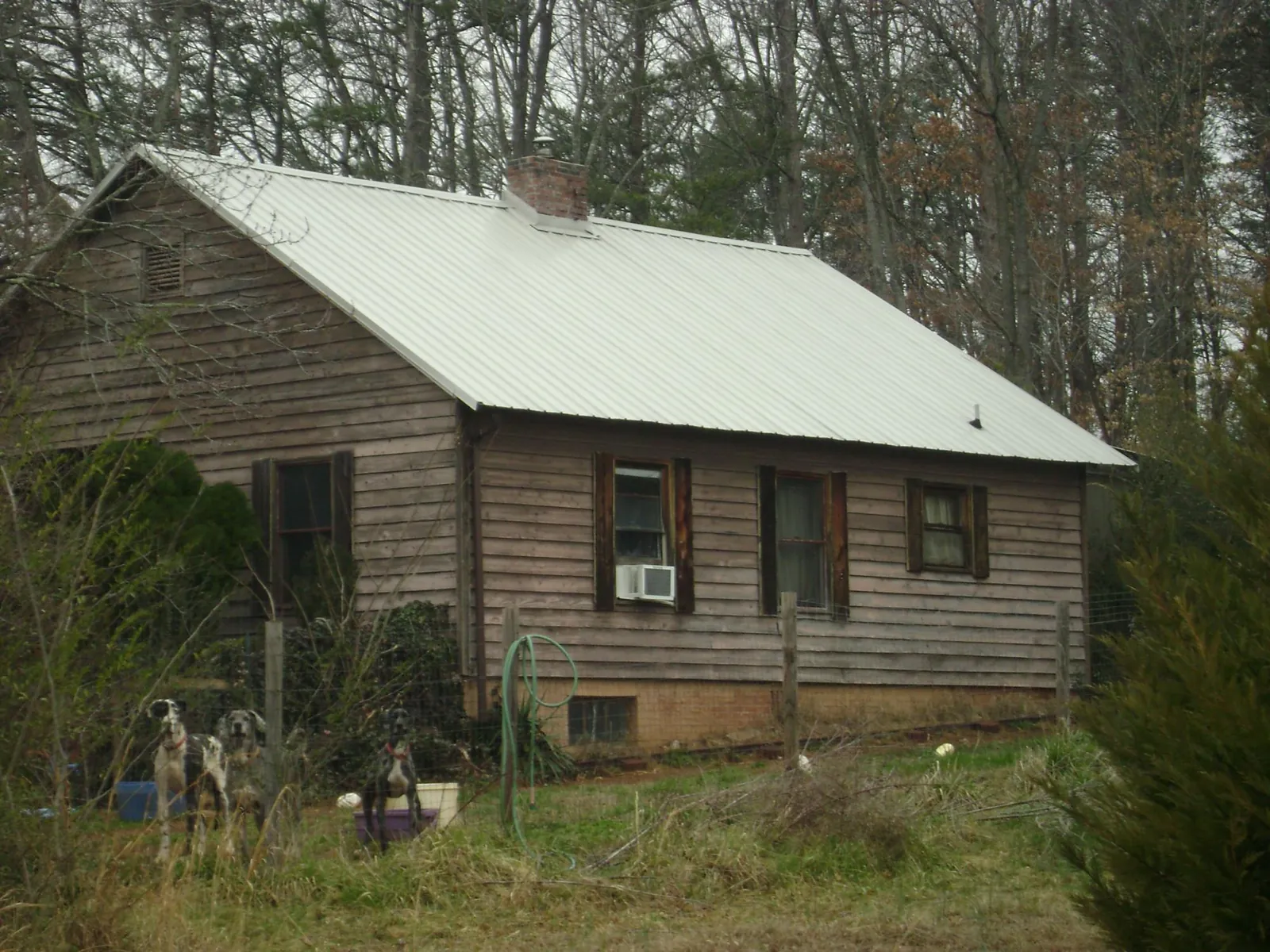 White metal roof on an old wood sided farmhouse, from a Metal Roof Installation job in Wisconsin Rapids